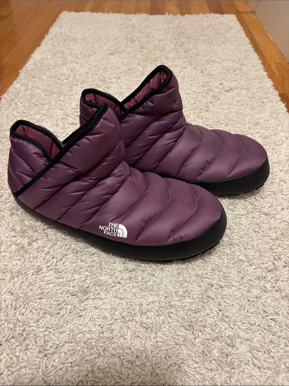 The North Face Quilted Slip-On Slippers in Plum with Black Trim